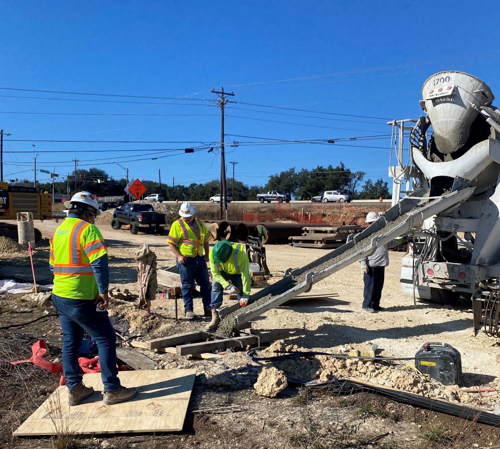 A truck delivers fresh concrete for a sound wall foundation near US 290 and South View Drive. Team members only have a few hours to pour concrete before it begins to harden after it is mixed. January 2022 