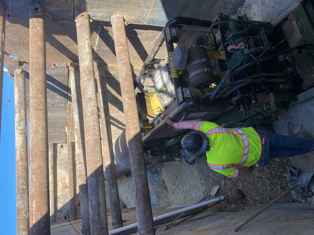 An Oak Hill Parkway team member supervises a boring machine drilling a tunnel for a waterline to run underneath US 290. This trenchless method of construction allows the work to take place while traffic flows safely and uninterrupted above. January 2022