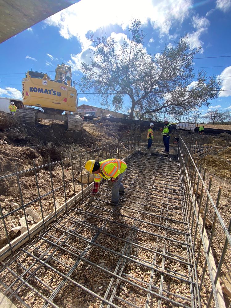 An Oak Hill Parkway team member installs rebar before concrete is poured for a future drainage culvert beneath US 290 near South View Road. Culverts are designed to channel water from one side of the roadway to the other, thereby limiting the amount of wa
