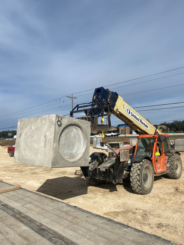 A forklift moves a drainage base box in preparation for installation near El Rey Boulevard. The Oak Hill Parkway Project design includes multiple drainage improvements along the US 290 and SH 71 corridors. January 2022