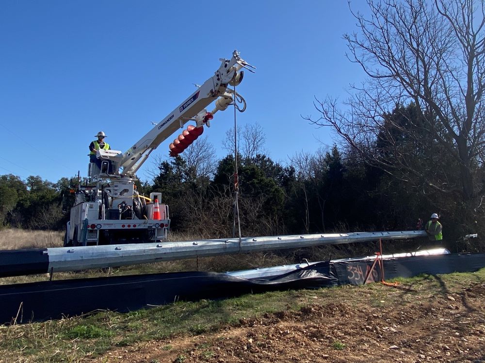 Austin Energy workers lift a new power pole into place at US 290 near Convict Hill Road. This utility relocation work will allow the team to build a new shared-use path for bicycles and pedestrians. March 2022