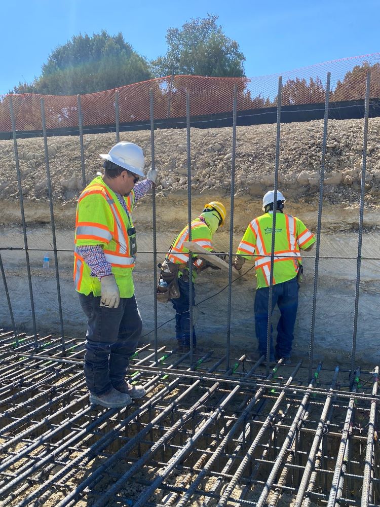 Oak Hill Parkway team members perform a quality check midway through construction of a cast-in-place wall near US 290 and RM 1826. Once the rebar is in place, the next step will be pouring the concrete wall foundation, or footer. February 2022    
