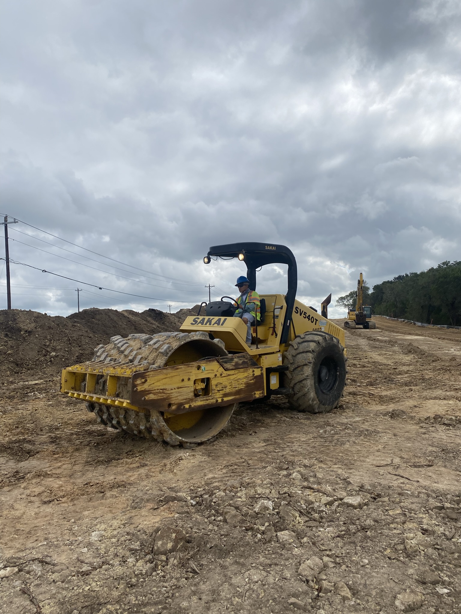 A piece of equipment called a “sheepsfoot roller” compacts dirt embankments in advance of grading activities for a new sound wall near South View Road. October 2021