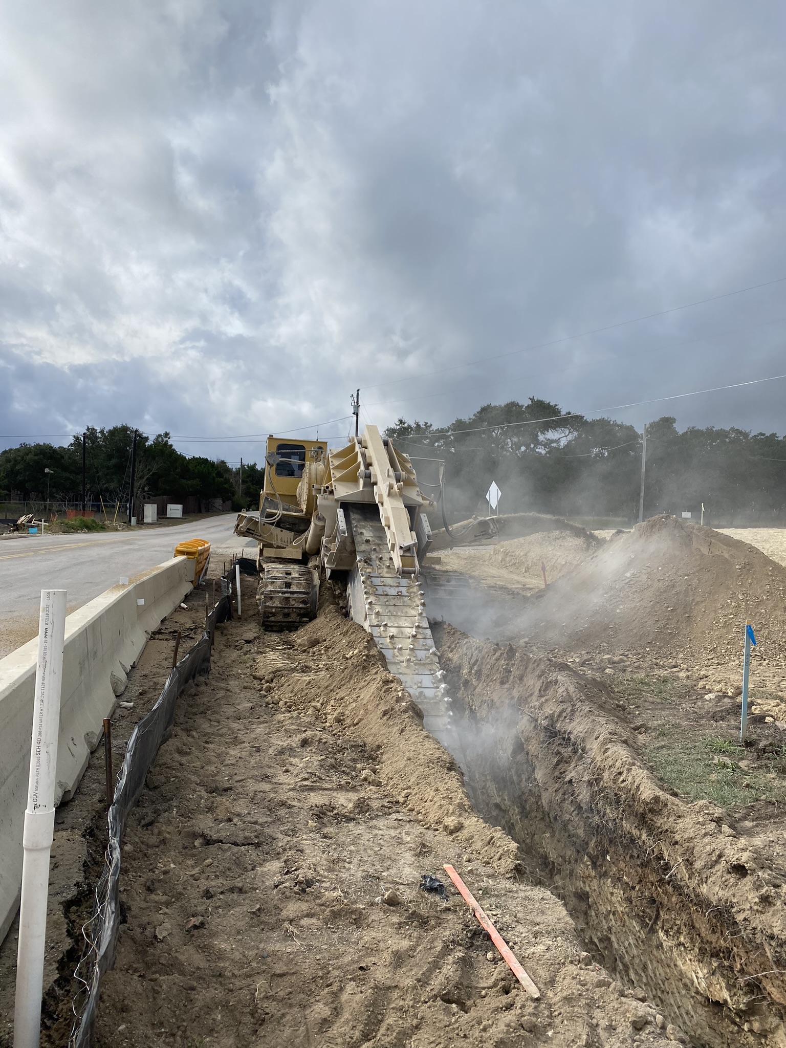 This trencher digs out the location for an underground utility line adjacent to El Ray Boulevard and US 290. December 2021