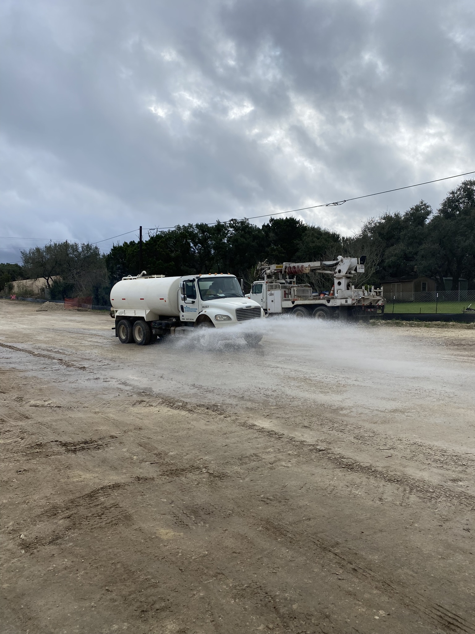 A water truck sprays down the job site's subgrade. This is one of the procedures the team uses to control dust in active construction areas. December 2021